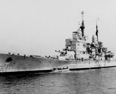 HMS Vanguard anchored in port.