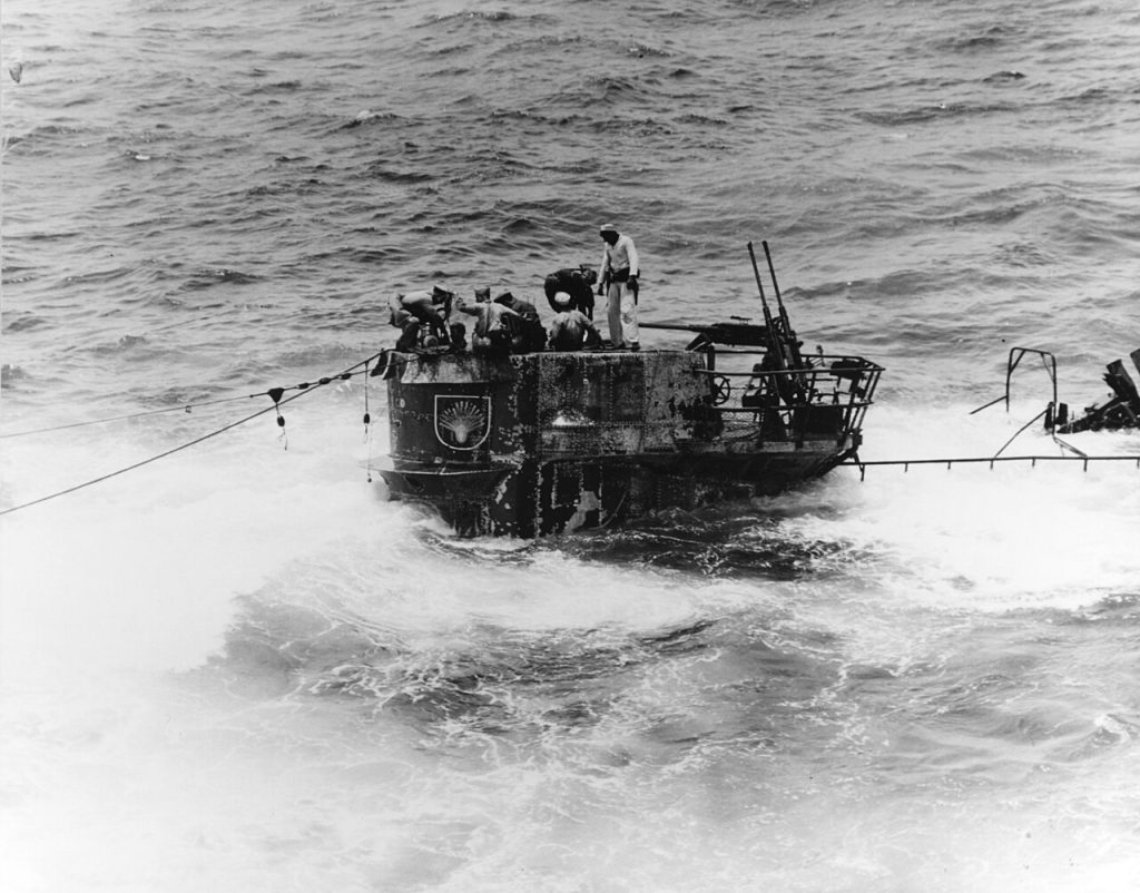Crew members from the USS Guadalcanal work ro remove water from the partially scuttled U-505. 