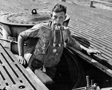 A crewman of the USS V-5 exiting the submarine wearing a Momsen Lung, July 1930.