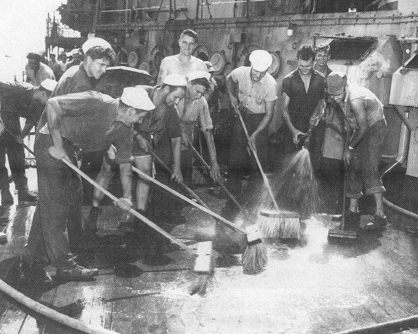 Sailors attempting to remove radioactive contamination from the deck of the Prinz Eugen. 